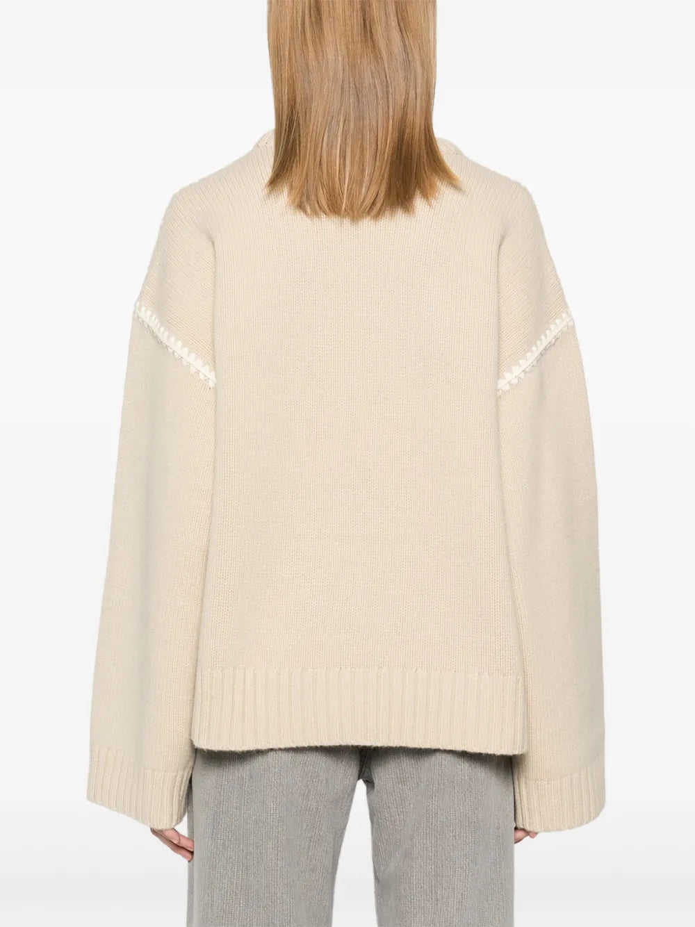 This embroidered wool jumper by Toteme combines minimalist design with luxurious craftsmanship. Made in Italy from high-quality wool, it features a subtle mélange effect in anthracite grey, highlighted by contrasting white whipstitch detailing. The knitted construction offers warmth and durability, while the crew neck, drop shoulders, and ribbed cuffs and hem provide a refined fit and comfortable wear. 