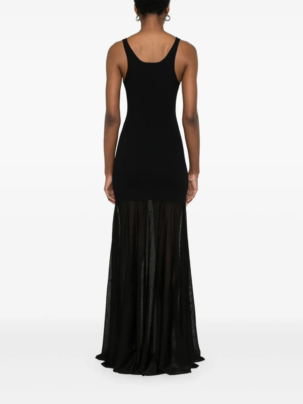 This black evening maxi dress by Toteme features a fine knit fabric with a panelled design that enhances its structured fit. The scoop neck and sleeveless cut create an elegant silhouette, while the unlined construction offers comfortable wear. The flared skirt flows gracefully into a long length, making it a sophisticated choice for formal occasions.