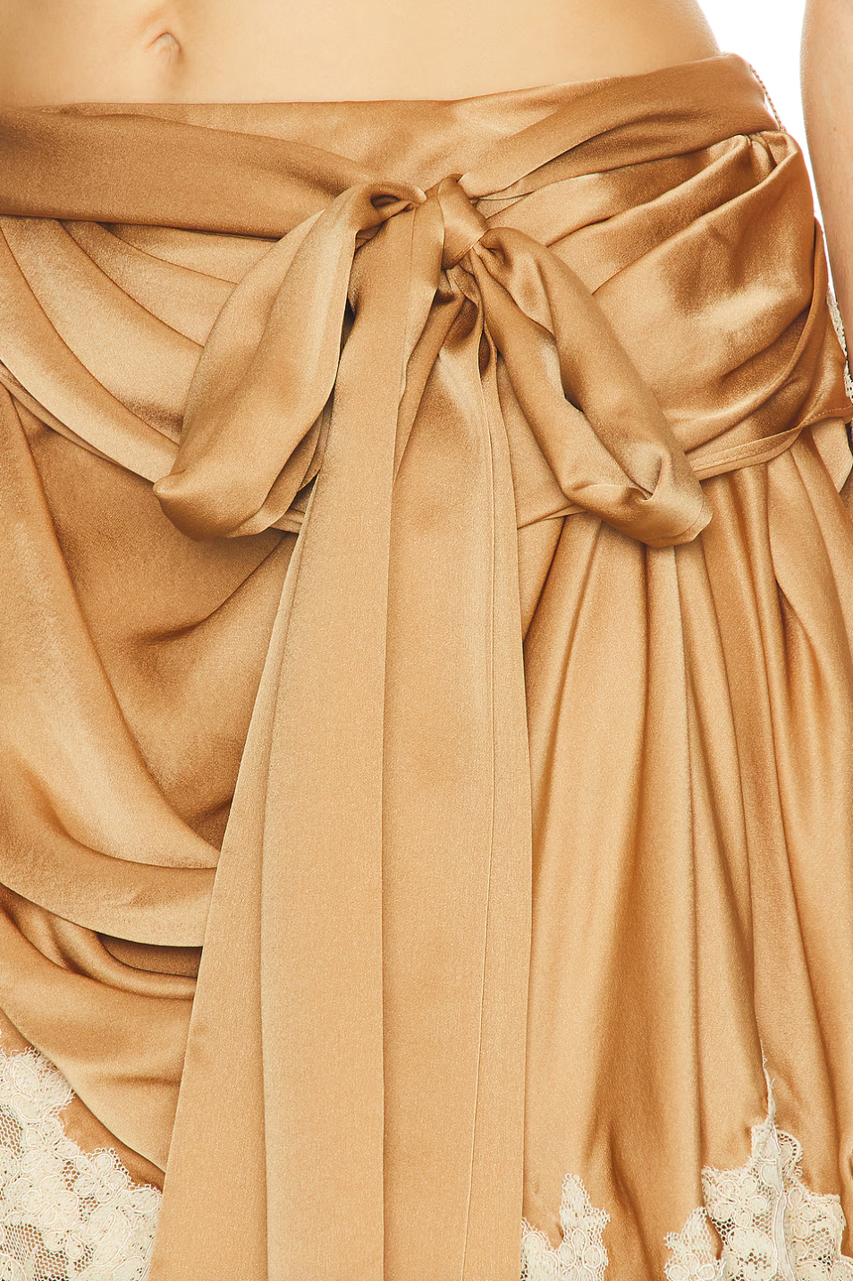 Crafted from midweight satin, the Hypnotic Satin Drape Skirt by Zimmermann features a refined asymmetrical hem accented with delicate lace trim for subtle elegance. Its partially lined design ensures comfort and movement, while a hidden back zip closure offers a sleek silhouette. The detachable belt with a front tie allows for versatile styling, making this skirt a sophisticated addition to any wardrobe. Please note, the piece is sold separately and not as a set.