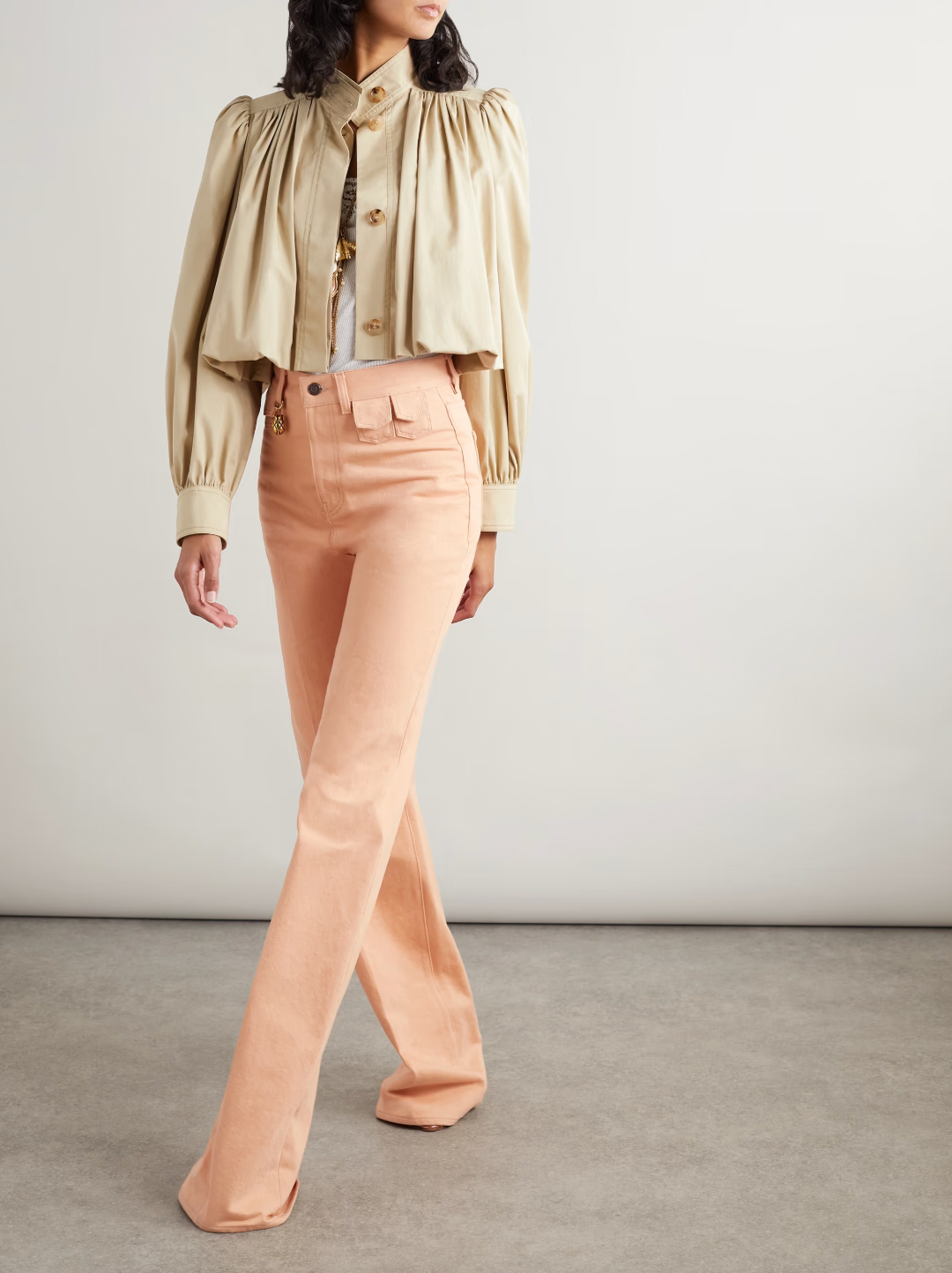 Chloé’s gathered cotton-twill jacket features a distinctive bubble hem and delicate gathers at the yoke and shoulders, offering a structured yet softly voluminous silhouette. Crafted from breathable cotton twill, it balances comfort with sophisticated tailoring. Ideal for layering, pair it with high-rise jeans and layered jewelry to channel the refined ease of the Spring ’25 runway. This jacket merges modern design with timeless wearability for a standout, expert-level addition to your wardrobe.