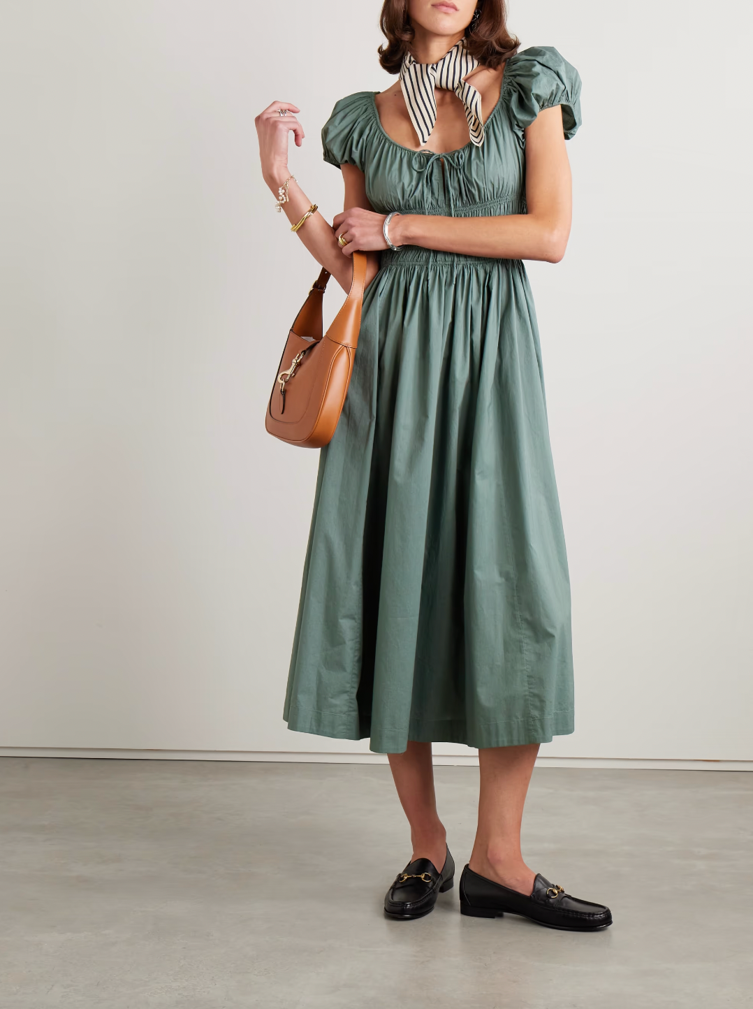 Crafted from organic cotton-poplin, the Quinn midi dress by Doen combines sustainable fabric with expert tailoring. Its shirred bodice and tie detailing create a flattering fit, enhancing natural curves while providing comfort. This versatile piece seamlessly transitions from day to evening, reflecting thoughtful design and eco-conscious materials in a refined silhouette.