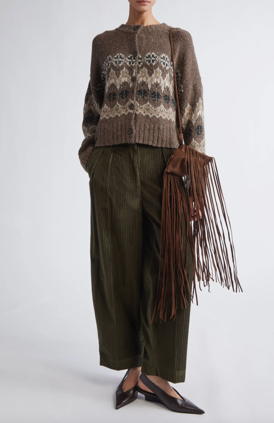 This sophisticated cardigan reimagines classic Fair Isle aesthetics through a contemporary lens, crafted from a textured wool blend that delivers both visual interest and warmth. The dropped-shoulder silhouette creates an effortlessly relaxed fit, while the traditional motif patterns add timeless appeal to your everyday rotation. 