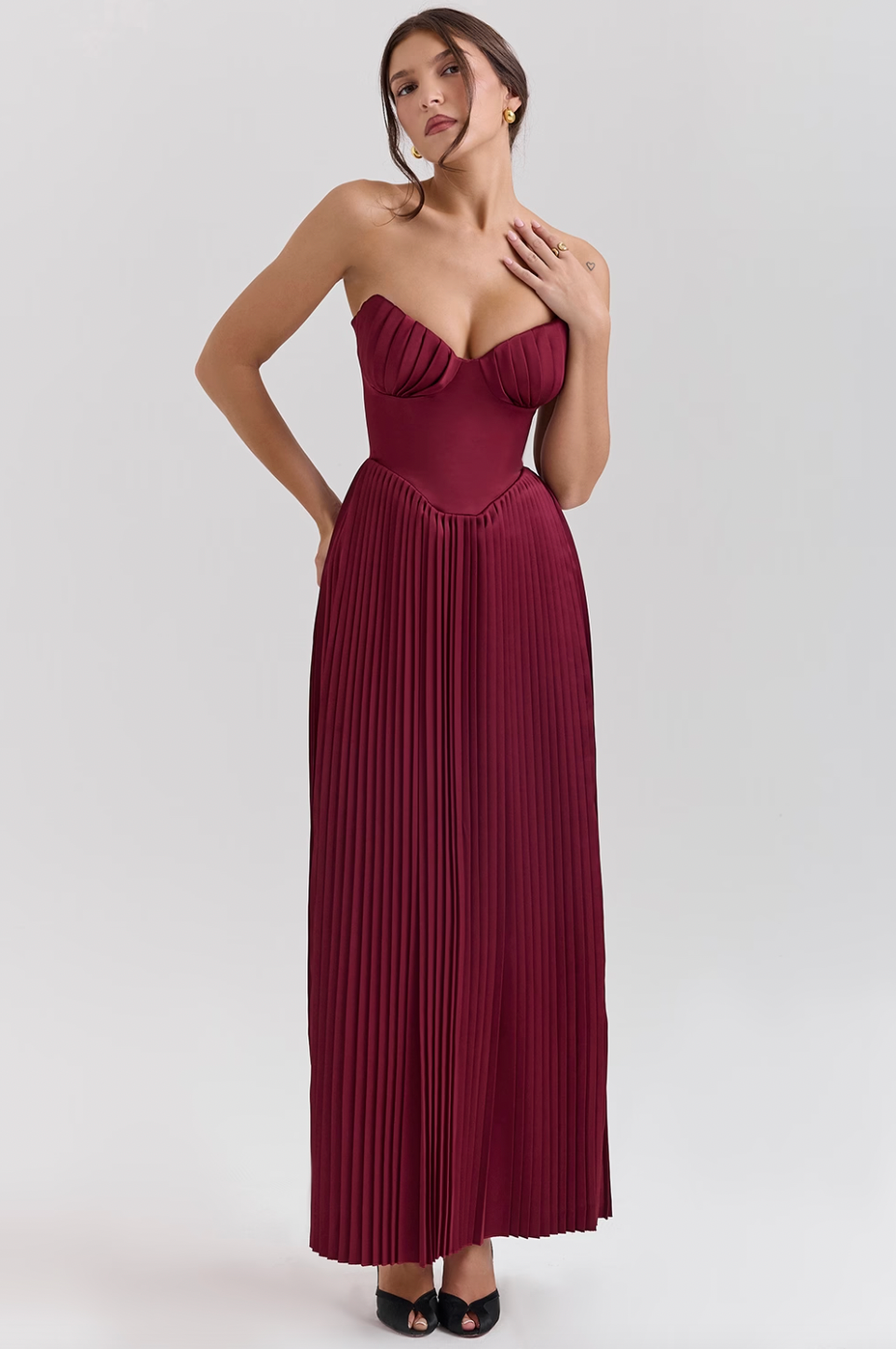Crafted from luxurious silky pleated satin the ethereal beauty of the 'Marcella' Dress creates a dreamy, romantic silhouette. The bust features elegant shell-shaped pleats that beautifully accentuate your décolletage, while the perfectly boned bodice cinches the waist for a flattering fit. The pleated maxi skirt flows effortlessly, ensuring that every step you take is nothing short of mesmerizing.
 