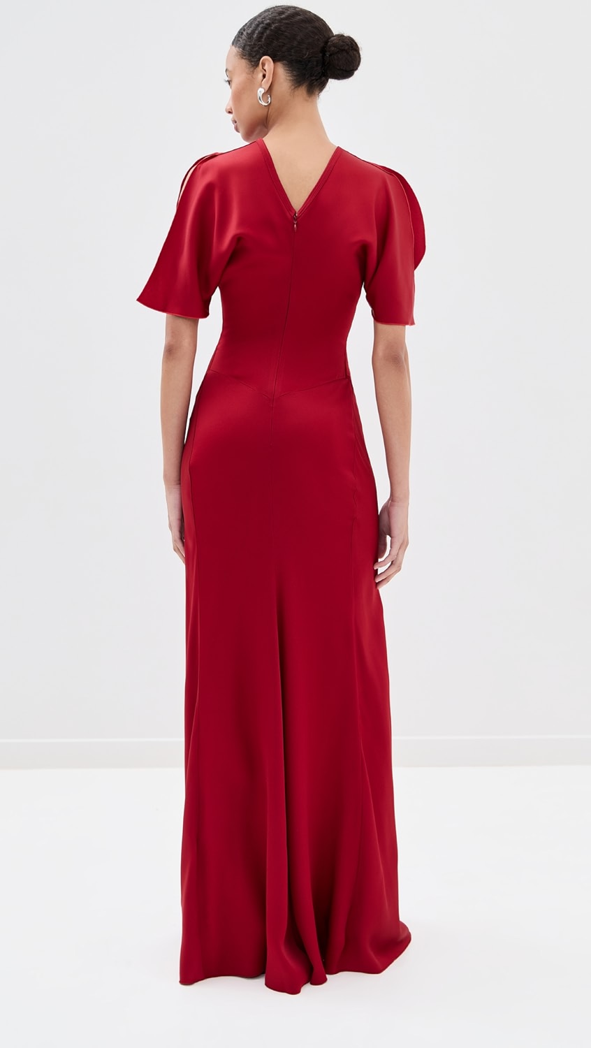 Elegant and refined, this floor-length dress by Victoria Beckham features luxurious mid-weight charmeuse that drapes beautifully without stretch. Strategic ruching at the waist creates a flattering silhouette while the crew neckline and short sleeves offer timeless sophistication. The hidden zip and hook-and-eye closure at the back ensure a seamless finish. Perfect for formal occasions and evening events where polished elegance is paramount.