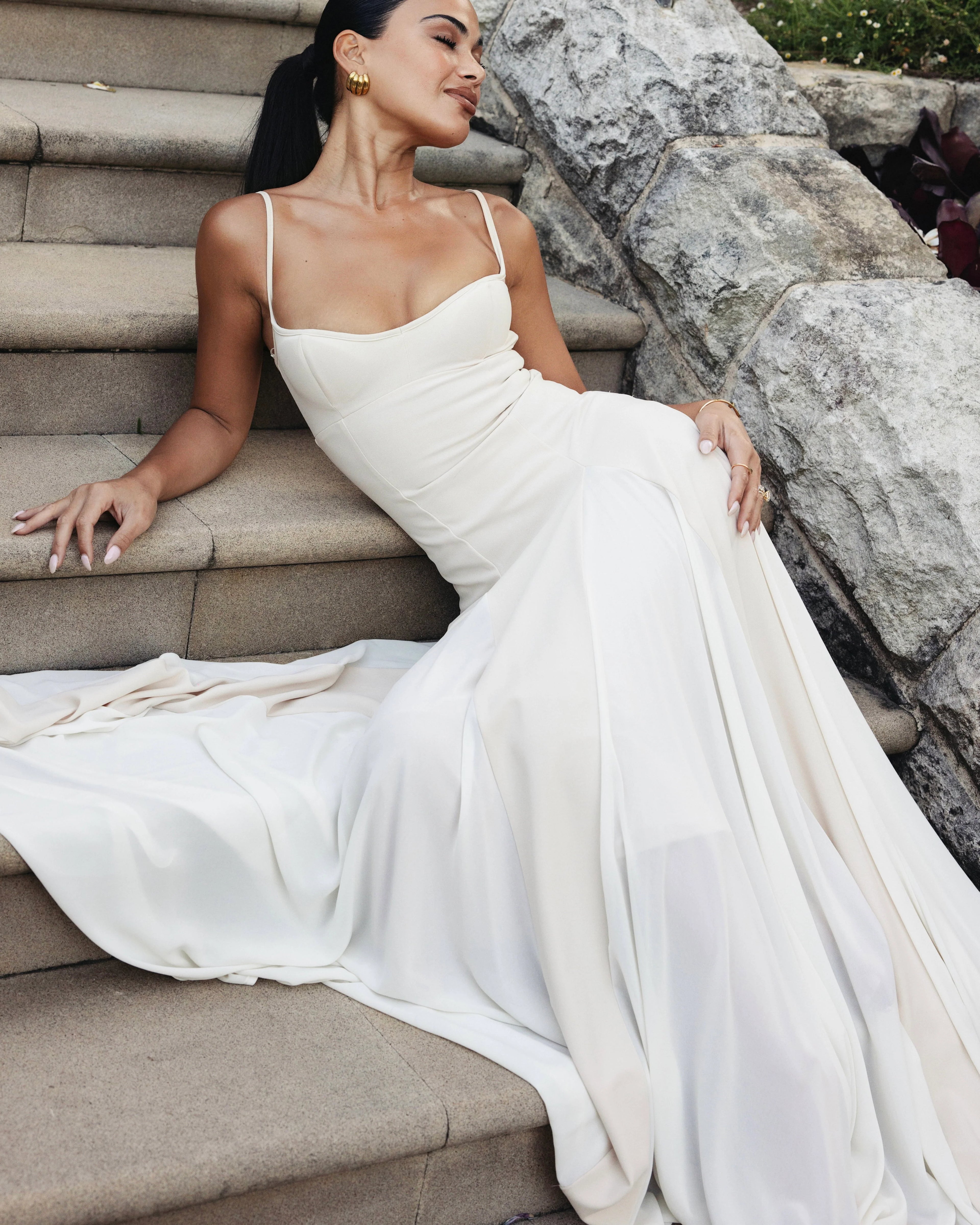Paloma Dress by Arcina Ori combines classic elegance with modern design, featuring a paneled A-line skirt crafted from white georgette that drapes smoothly off the hips and moves gracefully. Its contrasting accents enhance fluidity, making it ideal for memorable occasions. Equipped with padded bra cups and binded edges, it offers structured support and a flattering silhouette. Paloma delivers refined sophistication and confidence from every perspective.