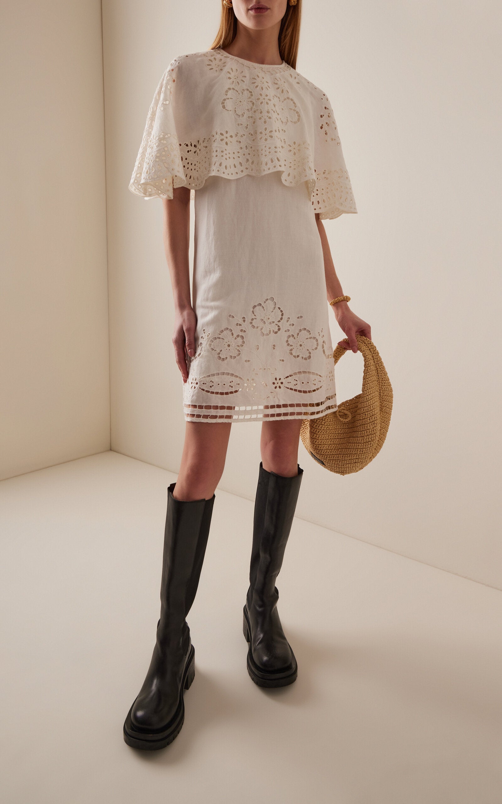 The Lulu Embroidered Linen-Blend Mini Dress by SEA New York combines breathable viscose-linen fabric with delicate eyelet embroidery for a refined texture. Its flouncy capelet adds a sophisticated silhouette, making it an ideal choice for warm-weather occasions where comfort meets understated elegance. This dress offers both lightweight wearability and distinctive design details for a polished, expert look.