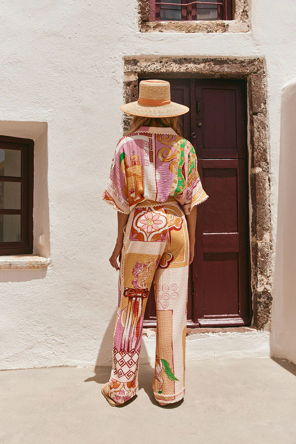 The Kelia Shirt in Theotokos Peach by Sabo is a boxy fit shirt featuring the exclusive Resort&nbsp; print. Made with a blend of viscose and nylon, this shirt offers a comfortable fit and stylish details such as a collar, low lapel, and ric rac trim. Perfect for adding a touch of unique elegance to your wardrobe.