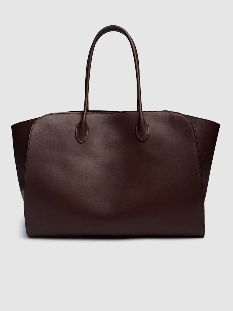 Crafted in Italy from 100% calf leather, the Marlo 17 Saddle Leather Tote Bag combines refined craftsmanship with practical design. Its chestnut hue complements double top handles for comfortable carrying, while a top toggle closure ensures secure access. The tote is lined and features an internal pocket to organize essentials, making it a sophisticated yet functional everyday accessory.