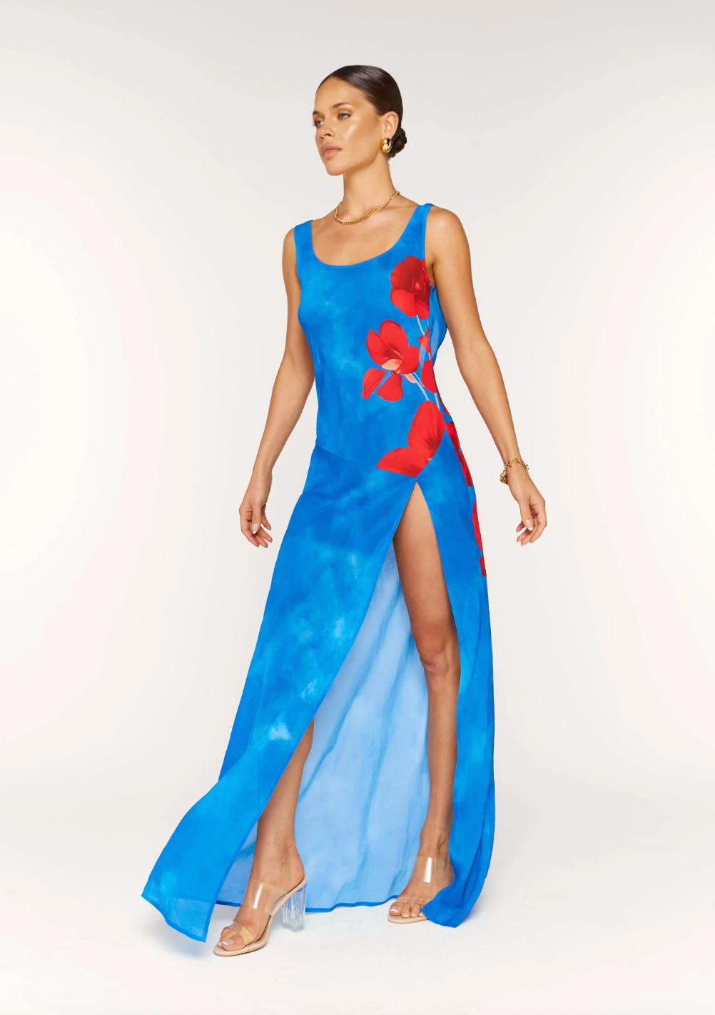 Enhance your style with the stunning Odette Dress. This versatile maxi dress is perfect for any event, featuring a flattering silhouette, high leg split, and charming print. The back cut out, neck tie, and scoop neckline add a touch of elegance to your look. Make a statement with every step in Odette.