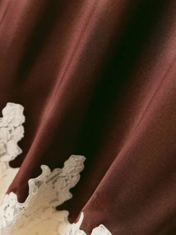 The Elowen Lace-Trimmed Silk-Charmeuse Midi Skirt by DÔEN offers a refined silhouette crafted from luxurious silk-charmeuse that gracefully flows with each movement. Its elasticated waistband ensures a comfortable, flattering fit, while the delicate lace trim along the midi-length hem adds an expertly tailored touch of elegance, making it suitable for both sophisticated daytime and evening occasions.