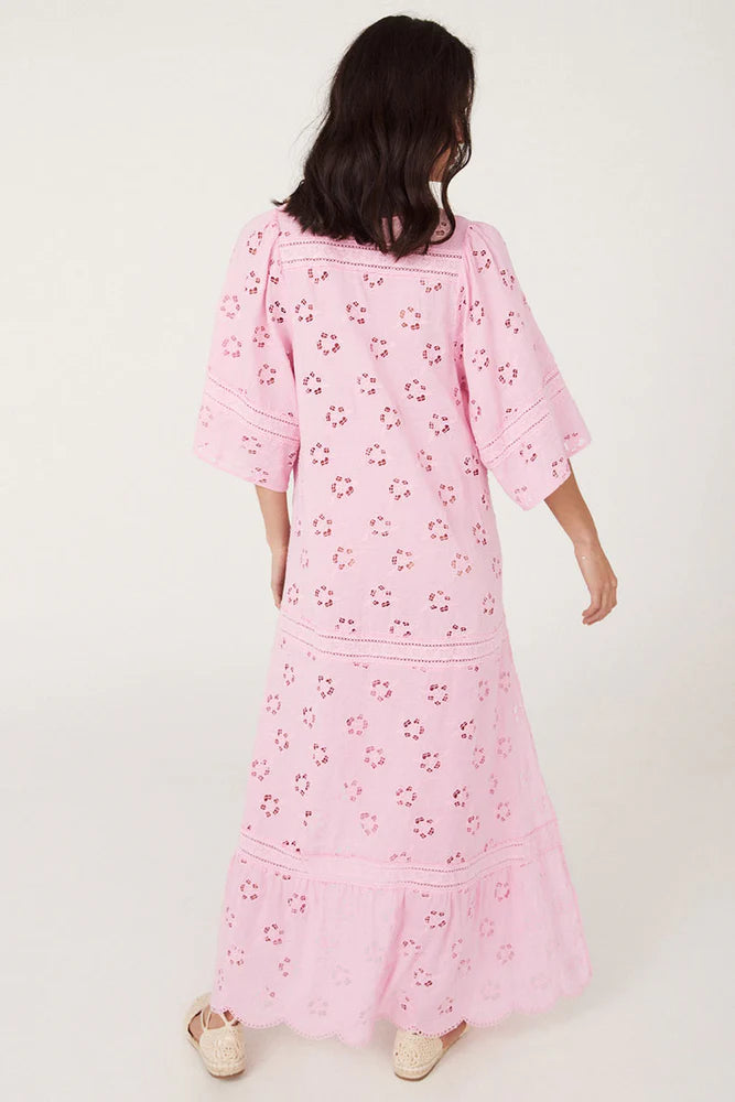 Step into a daydream with the Love Note Broderie Gown in Cosmos Pink, a gown that speaks of romance and delicate femininity. The soft pink hue, combined with custom embroidery and lace, lends an air of whimsy and beauty. A V-neckline with a keyhole opening at the centre front and side splits create a graceful, flowing silhouette, while flutter sleeves add a touch of fairytale magic. 