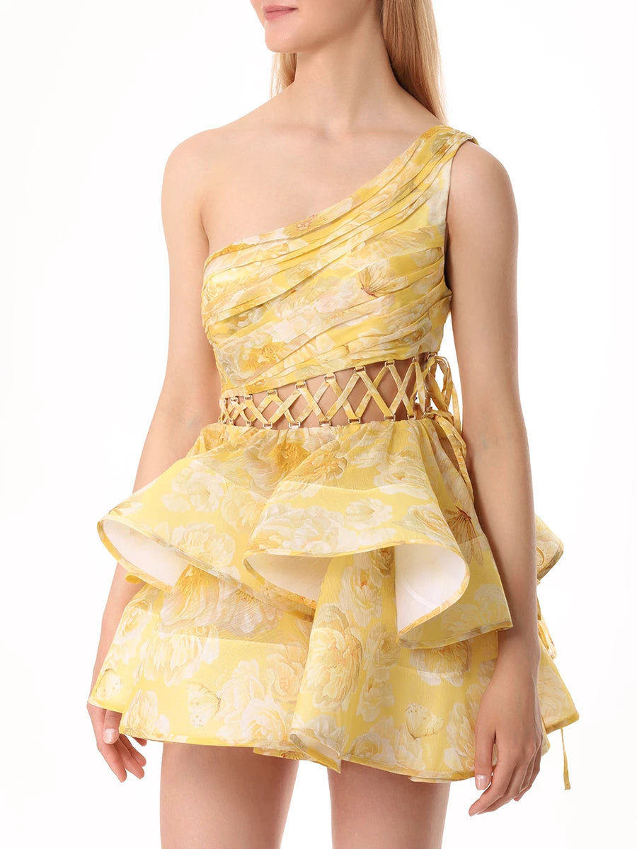 The Iris Dress by YVON is crafted from premium linen silk, showcasing an elegant yellow blend with a floral print inspired by fairy forest blossoms. Its handmade asymmetrical bodice defines femininity with subtle allure, while the waist lacing sculpts a striking silhouette. This dress balances romantic charm with sophisticated design for a truly unique statement piece.