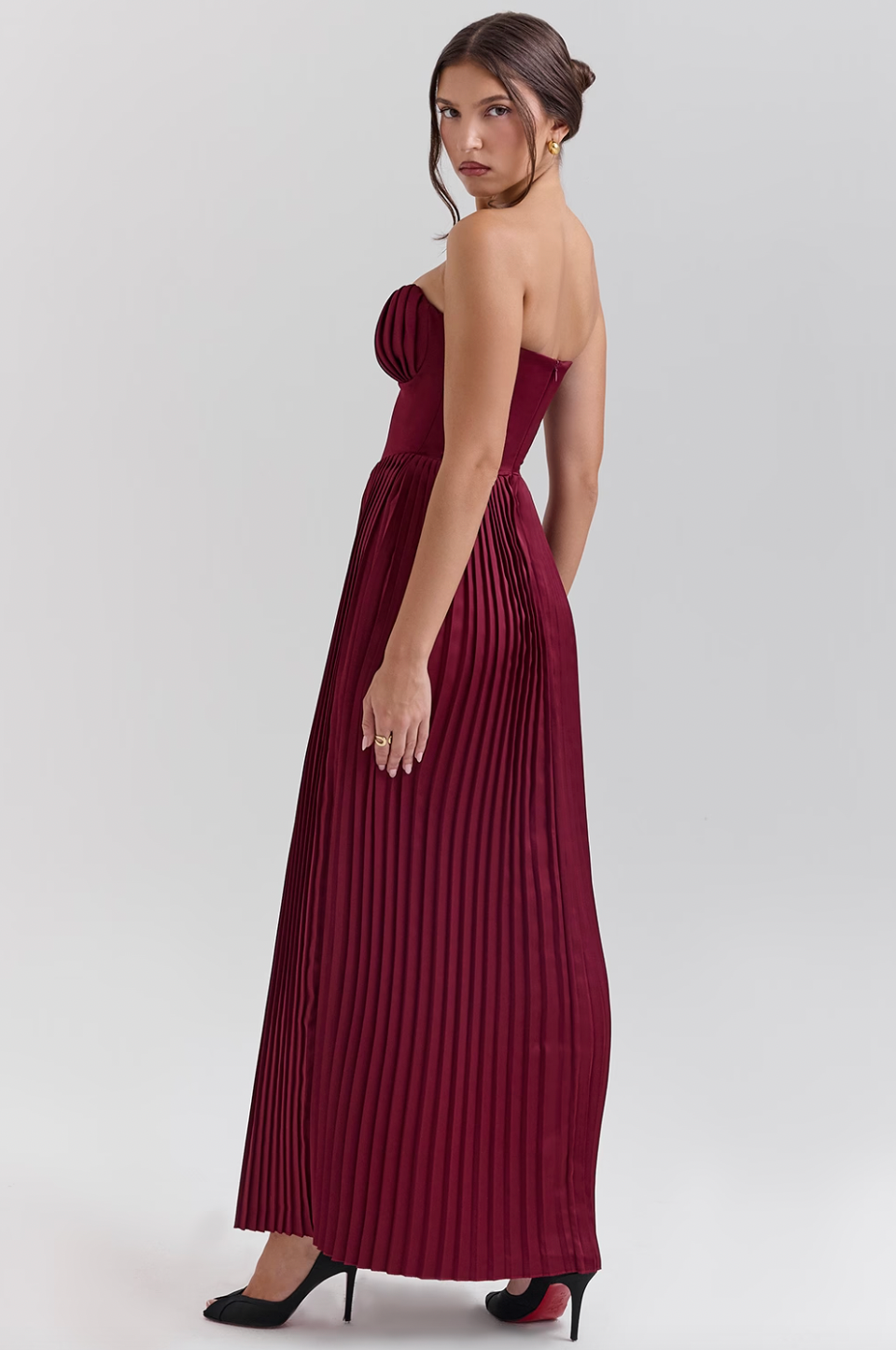 Crafted from luxurious silky pleated satin the ethereal beauty of the 'Marcella' Dress creates a dreamy, romantic silhouette. The bust features elegant shell-shaped pleats that beautifully accentuate your décolletage, while the perfectly boned bodice cinches the waist for a flattering fit. The pleated maxi skirt flows effortlessly, ensuring that every step you take is nothing short of mesmerizing.
 