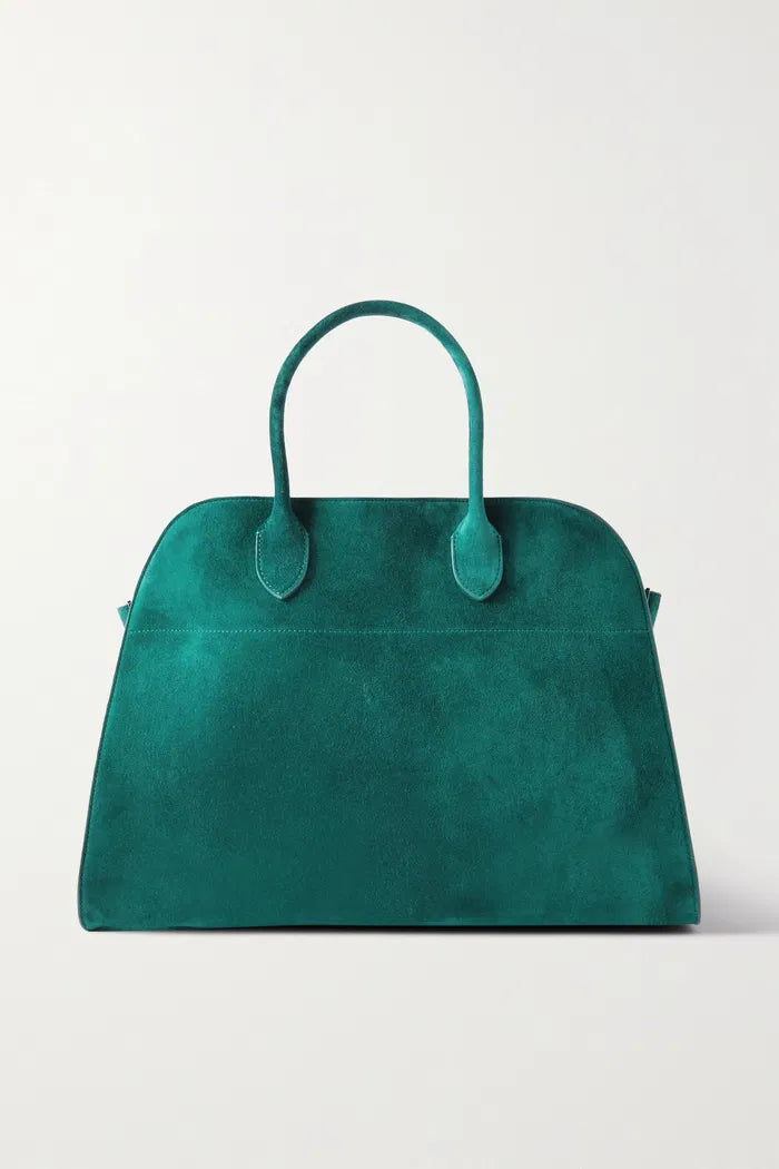 Crafted in Italy from smooth suede, the Margaux Air Suede Tote by The Row offers a softly structured silhouette enhanced by adjustable buckled sides for a customizable fit. Its thoughtful interior pockets provide secure storage for your essentials, merging elegant design with practical functionality. Made from 100% leather, this tote combines refined craftsmanship with everyday utility.