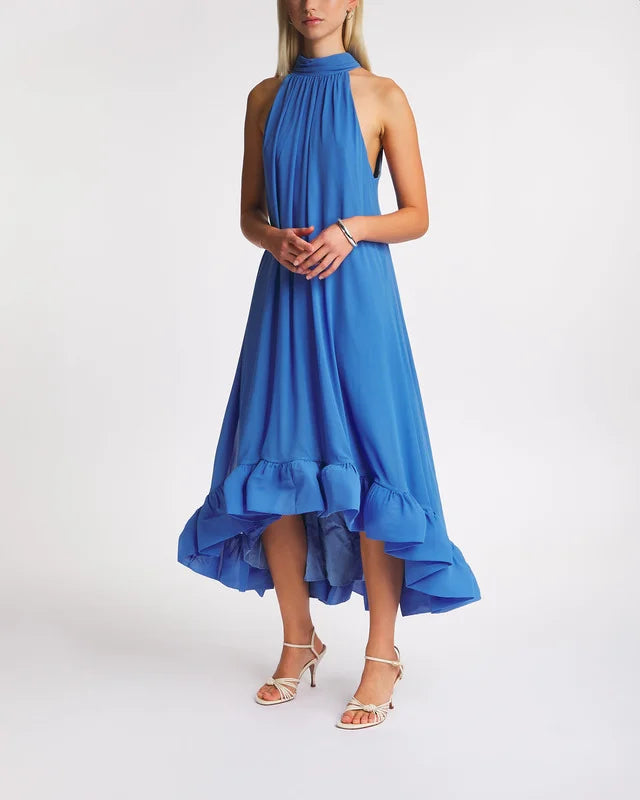 The Dress Sabrina Halterneck Ruffled Maxi by Malina features an elegant halterneck silhouette with a flattering open back. Its ruffled skirt adds movement and charm, while the tie at the neck ensures a customizable and secure fit. Perfect for formal occasions, this dress combines sophistication with feminine detail.