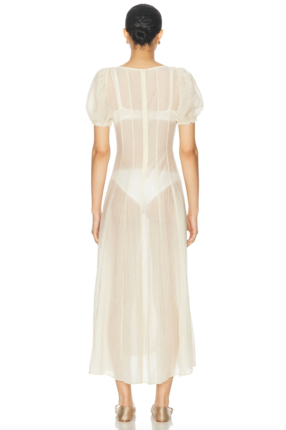 The Emory Dress features soft chiffon fabric and romantic puff sleeves with elastic cuffs for a flattering fit. Its sheer, unlined design gently reveals undergarments (not included), lending an ethereal quality. A discreet back zip maintains a sleek silhouette, while hand washing helps preserve its delicate texture. Ideal for those seeking a sophisticated and modern look with effortless elegance.