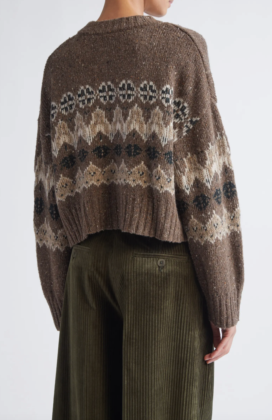 This sophisticated cardigan reimagines classic Fair Isle aesthetics through a contemporary lens, crafted from a textured wool blend that delivers both visual interest and warmth. The dropped-shoulder silhouette creates an effortlessly relaxed fit, while the traditional motif patterns add timeless appeal to your everyday rotation. 