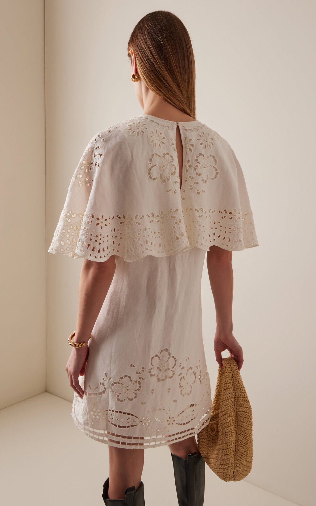 The Lulu Embroidered Linen-Blend Mini Dress by SEA New York combines breathable viscose-linen fabric with delicate eyelet embroidery for a refined texture. Its flouncy capelet adds a sophisticated silhouette, making it an ideal choice for warm-weather occasions where comfort meets understated elegance. This dress offers both lightweight wearability and distinctive design details for a polished, expert look.