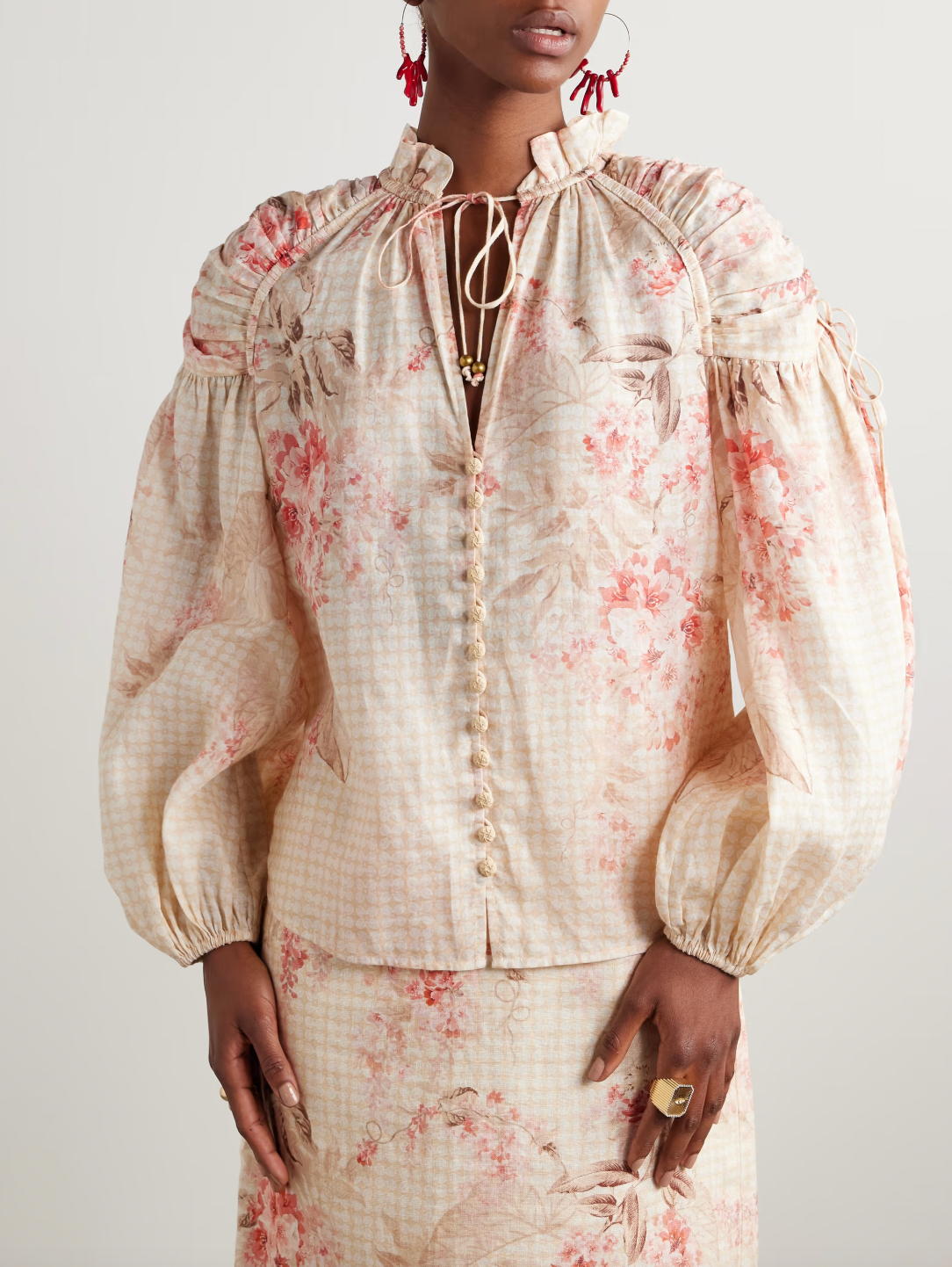 The Illuminate gathered printed ramie blouse by Zimmermann is crafted from breathable ramie fabric, offering natural comfort and durability. Its elegant gathered design enhances silhouette and movement, while the refined print adds a sophisticated touch. Ideal for both casual and dressier occasions, this blouse seamlessly combines airy texture with distinctive style.