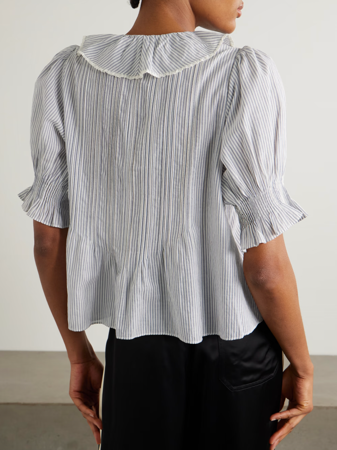 DÔEN's Henri top combines delicate detailing with sustainable craftsmanship. Crafted from organic striped cotton-voile, free from harmful pesticides, it features smocked puffed sleeves and lace-trimmed ruffles that frame the neckline. This top offers a refined, airy silhouette perfect for pairing with straight-leg jeans, balancing comfort with a sophisticated, vintage-inspired aesthetic.