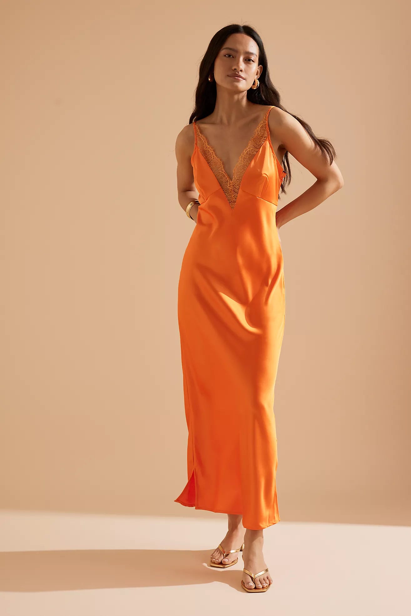 Elevate your ensemble with the Caetana dress, expertly designed to flatter with adjustable shoulder straps and a deep V-neck that accentuates your shape. The scalloped eyelash lace trim and side splits at the hem introduce delicate femininity and fluid movement, ensuring a poised and captivating presence at any occasion.