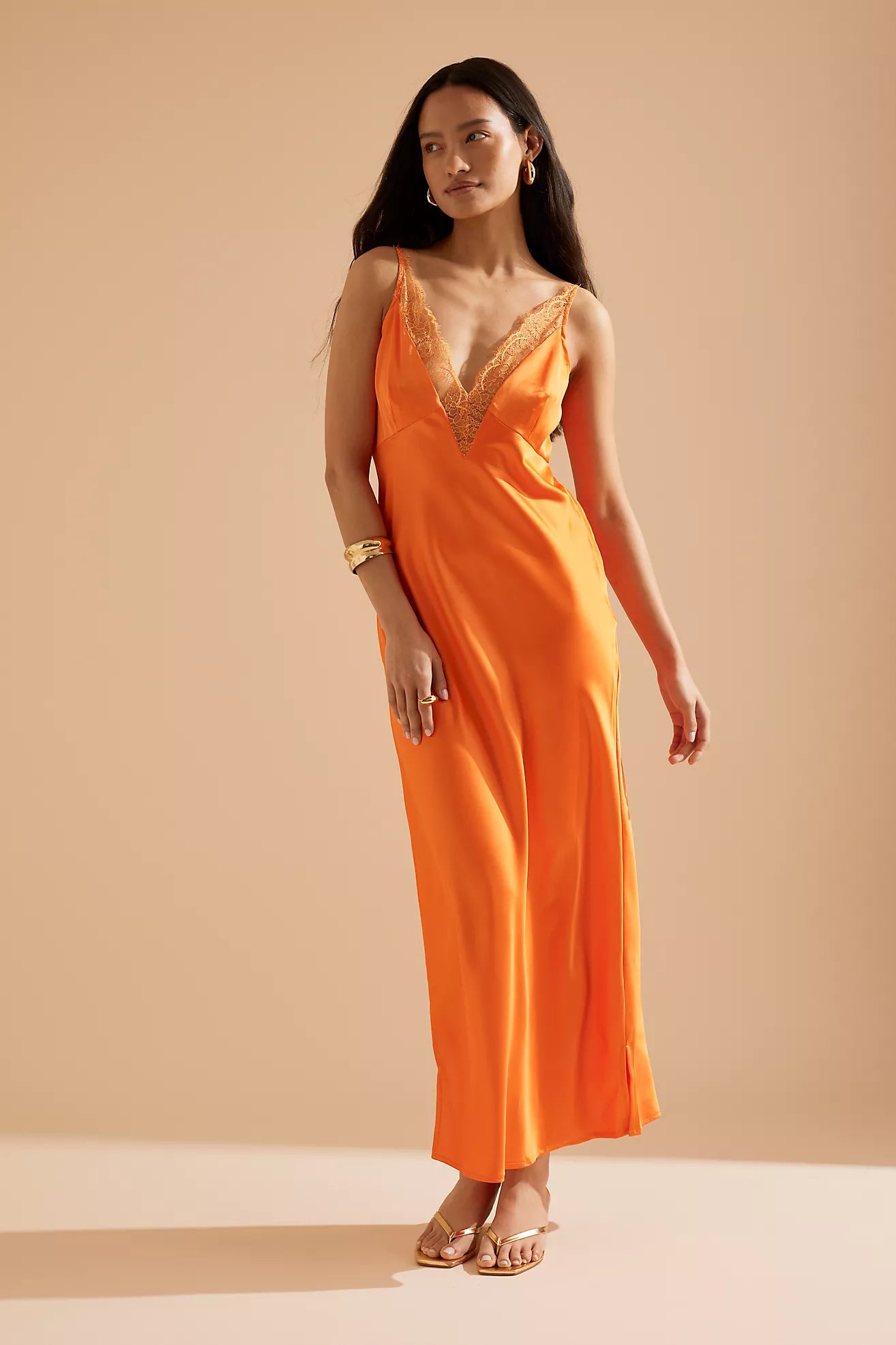 Elevate your ensemble with the Caetana dress, expertly designed to flatter with adjustable shoulder straps and a deep V-neck that accentuates your shape. The scalloped eyelash lace trim and side splits at the hem introduce delicate femininity and fluid movement, ensuring a poised and captivating presence at any occasion.