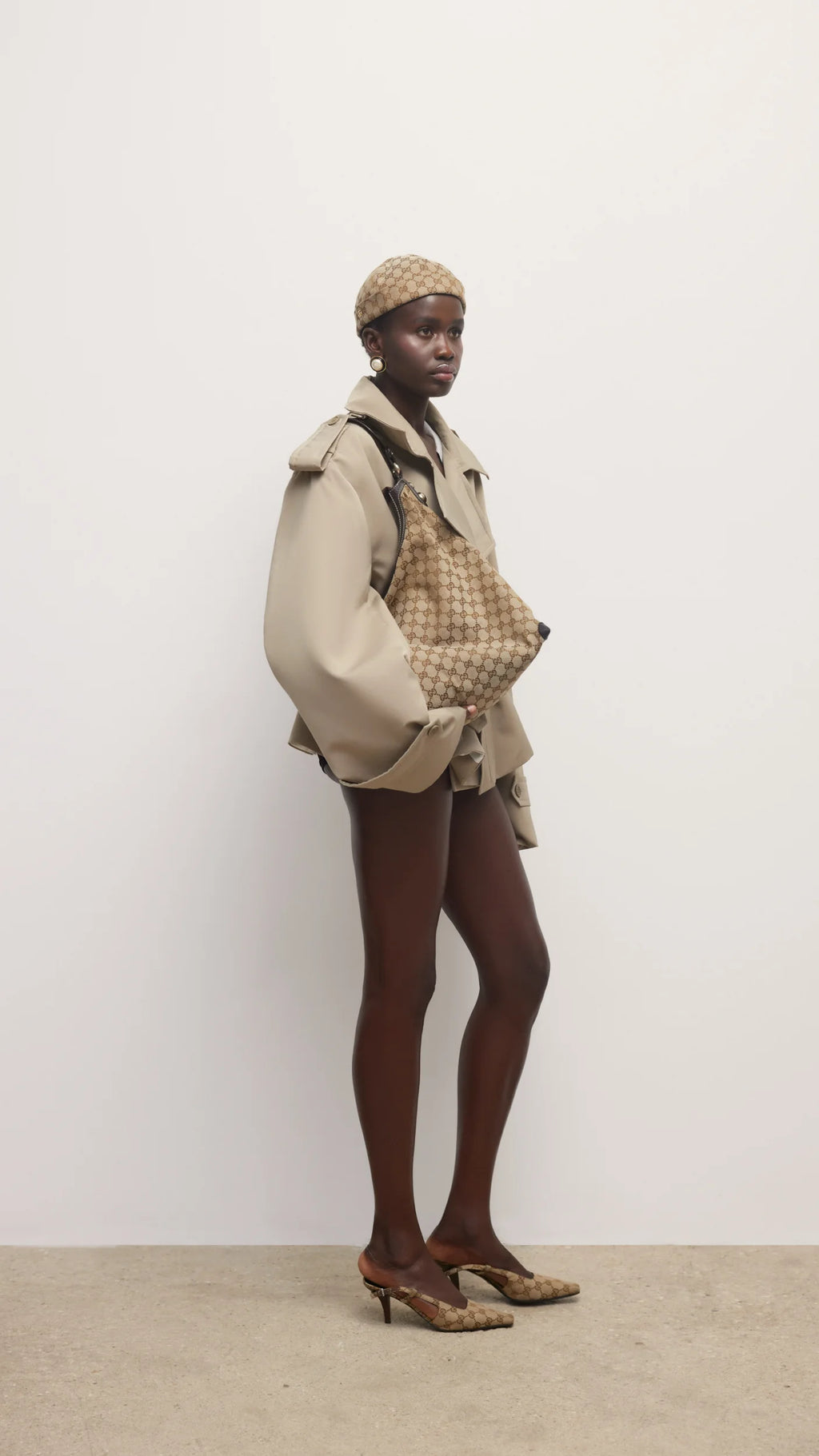 Elevate your wardrobe with this expertly tailored beige trench coat, offering a refined blend of classic design and contemporary appeal. The cropped silhouette enhances layering options, while the neutral beige shade ensures seamless coordination with varied outfits. Crafted for both comfort and style, this trench coat delivers a polished, sophisticated look that adapts effortlessly to different occasions. A versatile essential for a modern, elegant wardrobe.