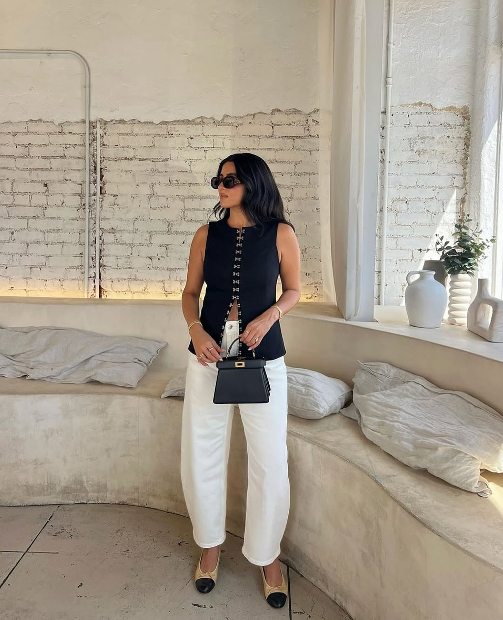 Elevate your fashion game with the Oyster Hook Crew Top in Black. Made from luxurious suiting fabric, this top boasts a sophisticated high neckline and flattering flared hemline. The adjustable gold hook and eye details add a touch of elegance and allow for customizable styling. Make a statement with this must-have piece.