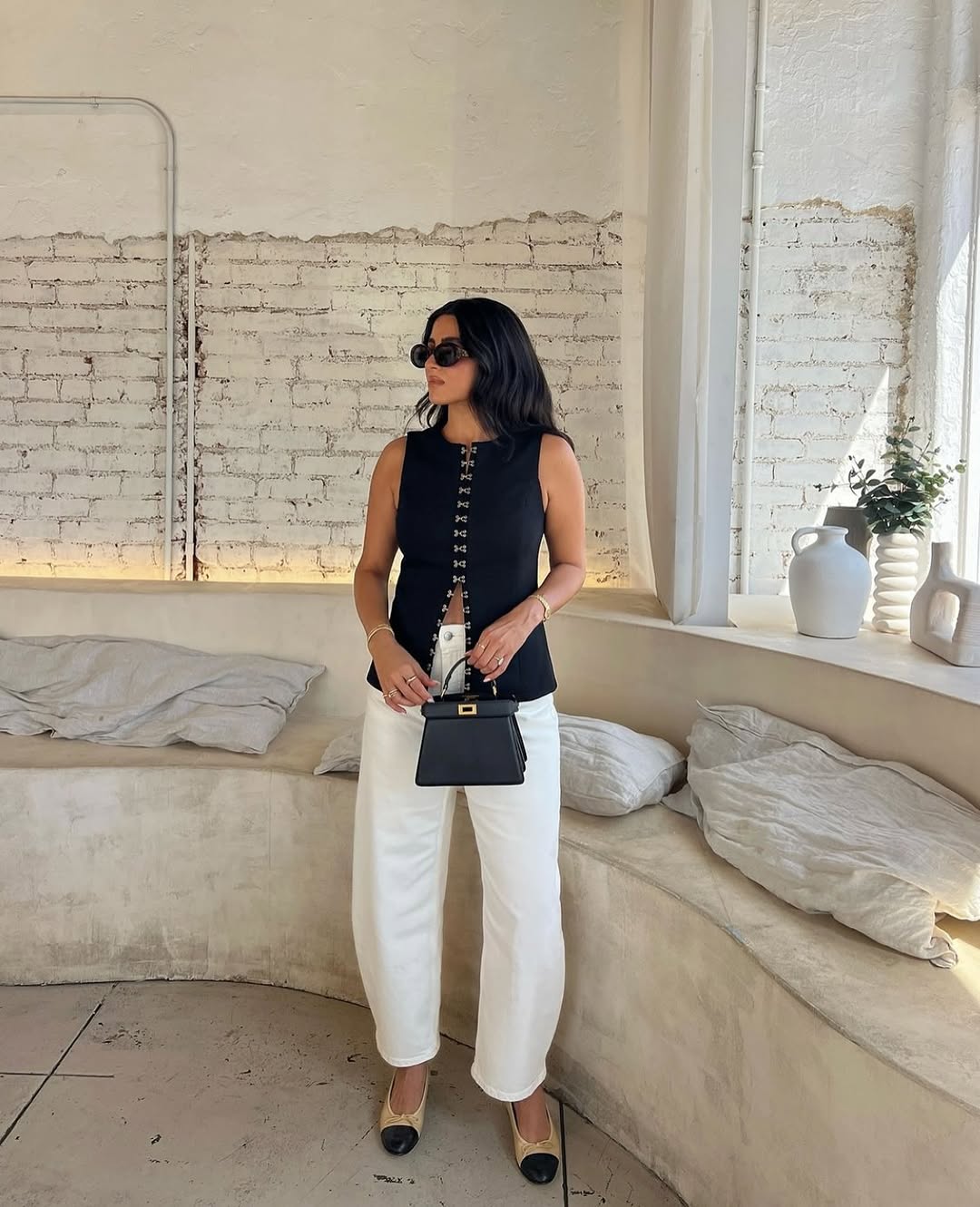 Elevate your fashion game with the Oyster Hook Crew Top in Black. Made from luxurious suiting fabric, this top boasts a sophisticated high neckline and flattering flared hemline. The adjustable gold hook and eye details add a touch of elegance and allow for customizable styling. Make a statement with this must-have piece.