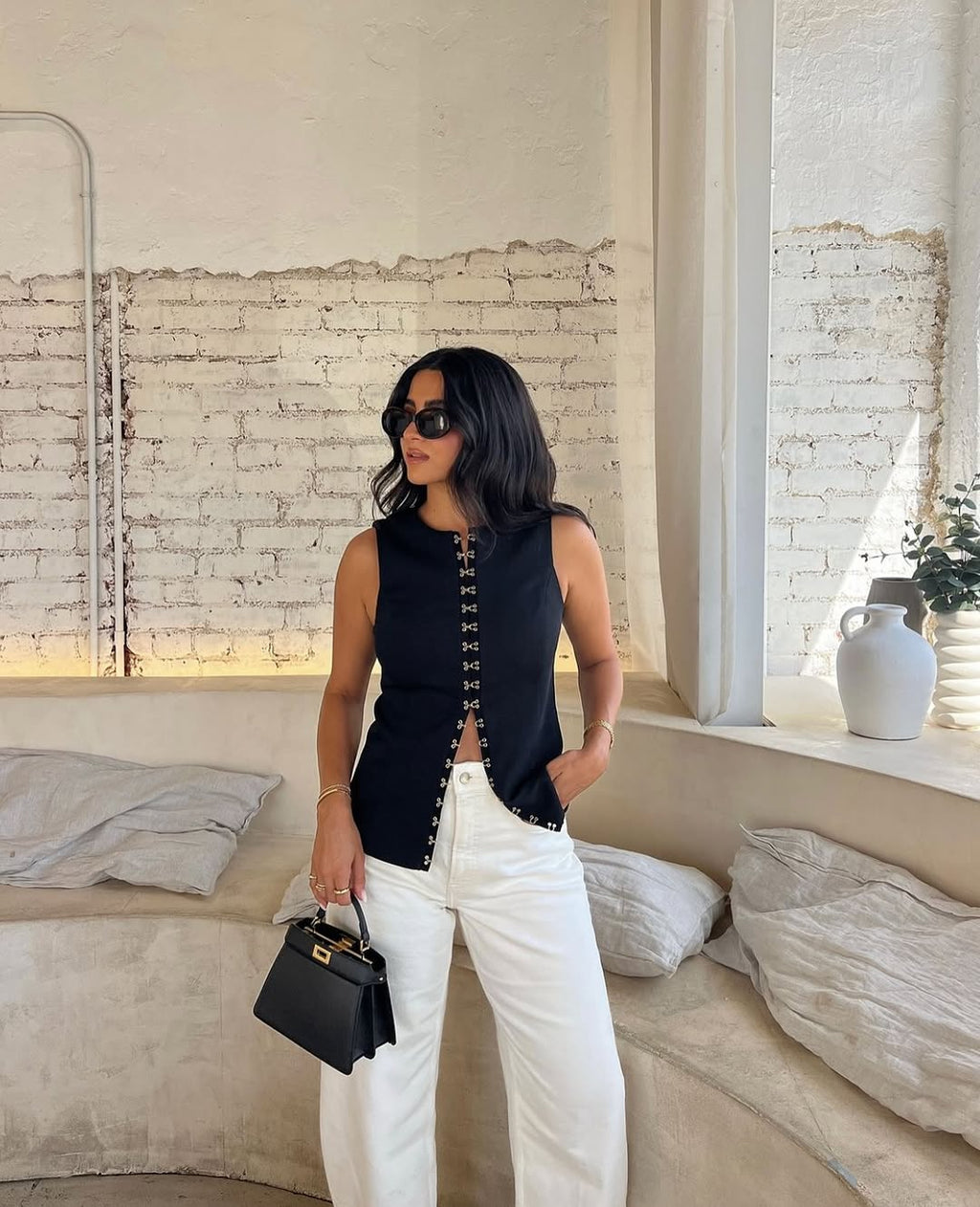Elevate your fashion game with the Oyster Hook Crew Top in Black. Made from luxurious suiting fabric, this top boasts a sophisticated high neckline and flattering flared hemline. The adjustable gold hook and eye details add a touch of elegance and allow for customizable styling. Make a statement with this must-have piece.