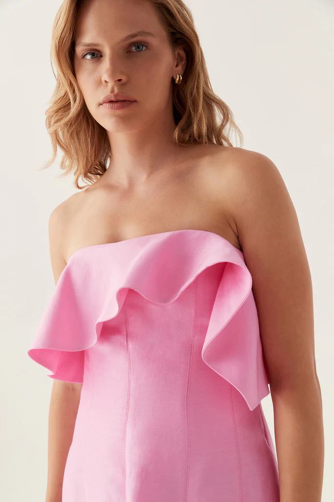 The AJE Shallows Strapless Gown epitomizes contemporary elegance with its minimalist silhouette and refined construction. This strapless design features a structured bodice that provides confident support while maintaining a sleek, uninterrupted neckline. The gown's clean lines and sophisticated draping create a timeless aesthetic suitable for formal occasions, evening events, or statement-making moments. 