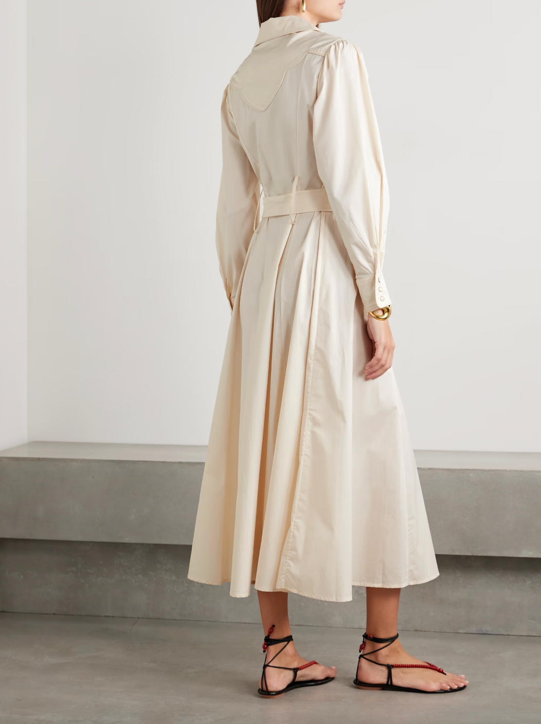 Johanna Ortiz’s Vela De Cruz midi shirt dress elevates a timeless silhouette with expertly tailored cotton-blend poplin. The finely pleated fabric adds refined texture, while the self-tie belt accentuates the waist for a flattering shape. Carefully selected tonal and silver-tone buttons enhance the sophisticated appeal, making this dress a versatile choice for polished, confident dressing.