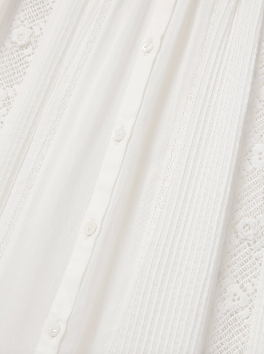 The Phoebe cotton-voile midi dress by DÔEN combines vintage charm with sustainable design. Crafted from organic cotton-voile, it features delicate lace trims and a classic Peter Pan collar. The dress gently cinches at the waist before flowing into a soft, floaty skirt, complemented by subtly puffed sleeves. This piece offers a refined, romantic silhouette ideal for those seeking timeless elegance with eco-conscious materials.