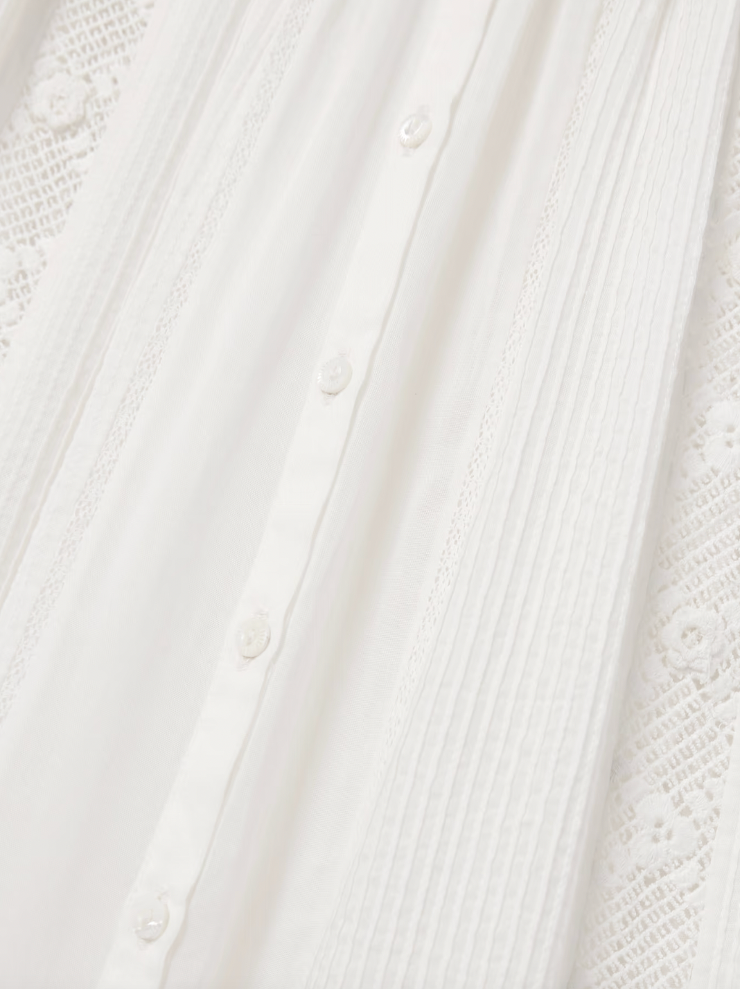 The Phoebe cotton-voile midi dress by DÔEN combines vintage charm with sustainable design. Crafted from organic cotton-voile, it features delicate lace trims and a classic Peter Pan collar. The dress gently cinches at the waist before flowing into a soft, floaty skirt, complemented by subtly puffed sleeves. This piece offers a refined, romantic silhouette ideal for those seeking timeless elegance with eco-conscious materials.