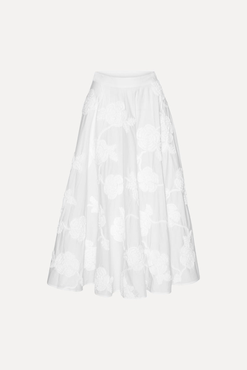 The Flower Maxi Skirt in Bright White combines elegance with comfort through its high-waisted design and voluminous flare, offering a flattering silhouette. Meticulously crafted with tonal floral embroidery, this skirt adds subtle sophistication to any outfit. Soft gathers at the waistband enhance its shape while a concealed side zipper ensures a seamless fit, making it a refined choice for both casual and formal occasions.