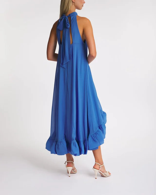 The Dress Sabrina Halterneck Ruffled Maxi by Malina features an elegant halterneck silhouette with a flattering open back. Its ruffled skirt adds movement and charm, while the tie at the neck ensures a customizable and secure fit. Perfect for formal occasions, this dress combines sophistication with feminine detail.