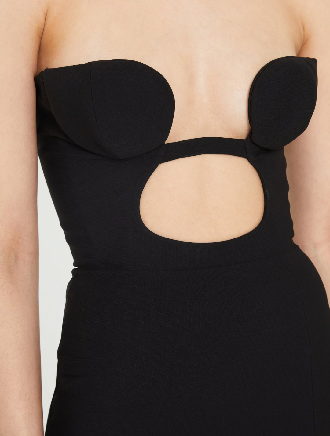 Nensi Dojaka's Volute Cut-out Dress in Jersey expertly balances bold design with flattering fit. Crafted from soft jersey and featuring a built-in padded bra, this dress provides seamless support while enhancing your silhouette. The striking front cut-out paired with a thigh-high slit creates an effortlessly dramatic look that commands attention without sacrificing comfort. Ideal for making a statement with refined ease.
