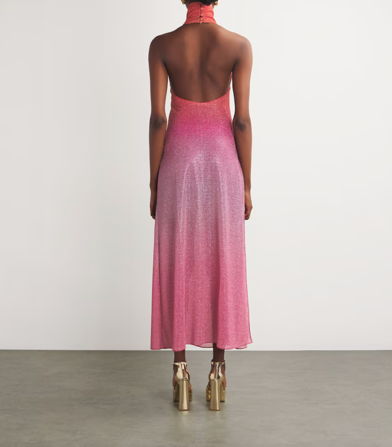 Experience elegance and modern sophistication with the OSÉREE Lumière Ombrè Metallic Stretch-Knit Halterneck Maxi Dress. Crafted from shimmering metallic stretch-knit fabric, this dress offers both comfort and a flattering fit that contours your silhouette. The ombrè effect adds depth and visual interest, while the halterneck design highlights the shoulders for a graceful, refined look. 