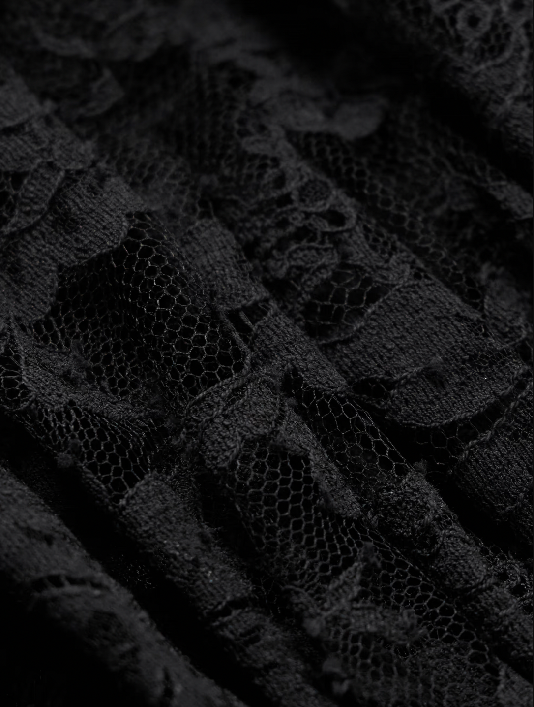 Elevate your evening wardrobe with this exquisite gown from Alessandra Rich. Crafted from sumptuous velvet and delicate lace, this piece seamlessly blends texture and refinement. The signature bow detail adds a touch of feminine elegance, creating a striking focal point that captures attention. Perfect for galas, formal celebrations, or any occasion demanding understated luxury, this gown drapes beautifully to flatter the silhouette while maintaining an air of timeless sophistication.