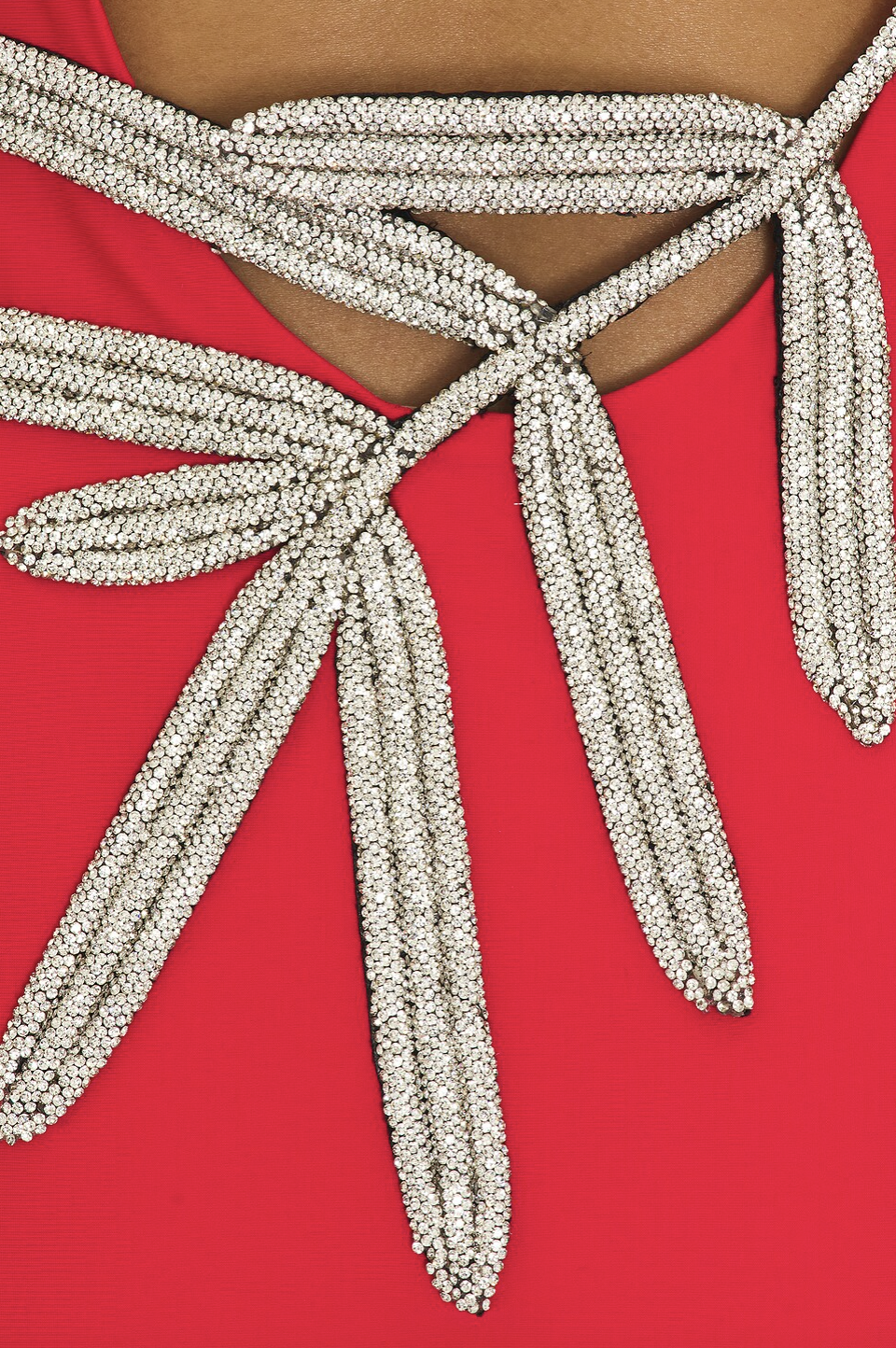 The Sabrine Dress combines elegance with subtle allure, featuring a low-cut back adorned with a delicate rhinestone-embellished leaf design that adds a refined sparkle. Crafted from slinky jersey fabric, it offers a smooth drape and comfortable fit, ideal for sophisticated occasions demanding both style and ease.