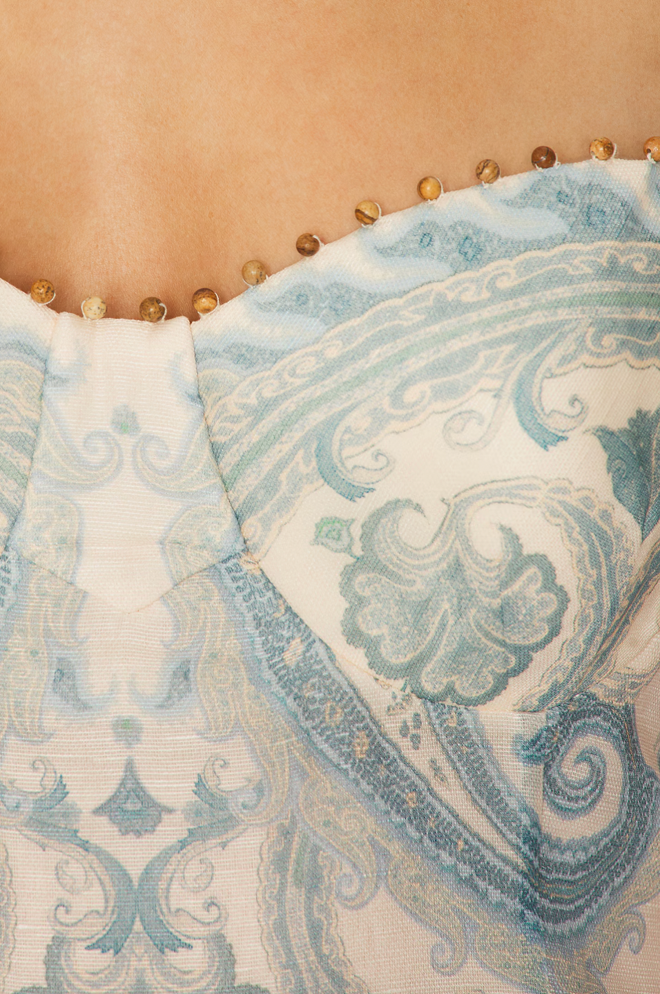 The Illuminate Gown by Zimmermann features a fully lined bustier design that ensures a flattering fit and comfortable wear. Its hidden back zipper closure offers a sleek silhouette, while adjustable shoulder straps provide customizable support. Crafted from premium linen, the gown combines breathable comfort with a structured skirt detail, lending an elegant and refined shape suitable for sophisticated occasions.