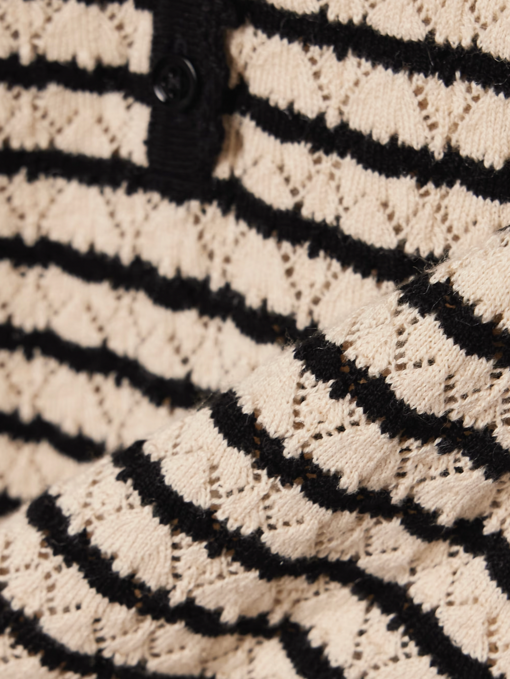 The Brandie striped pointelle-knit top by DÔEN blends cotton and silk for a soft, breathable feel. Its delicate pointelle-knit detailing and contrasting stripes add subtle texture and visual interest. Designed with a slightly loose fit, it features scalloped trims on the crew neckline, short sleeves, and hem for a refined finish. 