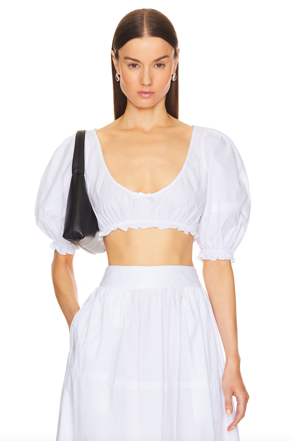The Poplin Cropped Peasant Top by Helsa features airy puff sleeves with elastic cuffs for comfortable movement and a flattering silhouette. A delicate bow detail at the front adds a subtle touch of charm, while the elastic underband ensures a secure yet flexible fit. Crafted from lightweight poplin fabric, this top offers breathability and a crisp, polished appearance ideal for warm-weather styling.