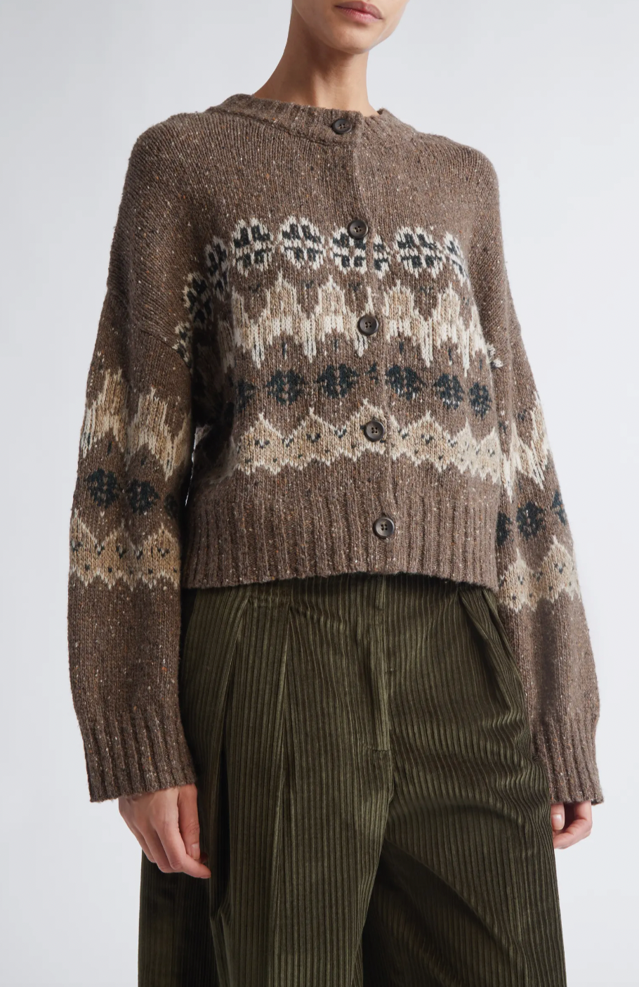 This sophisticated cardigan reimagines classic Fair Isle aesthetics through a contemporary lens, crafted from a textured wool blend that delivers both visual interest and warmth. The dropped-shoulder silhouette creates an effortlessly relaxed fit, while the traditional motif patterns add timeless appeal to your everyday rotation. 