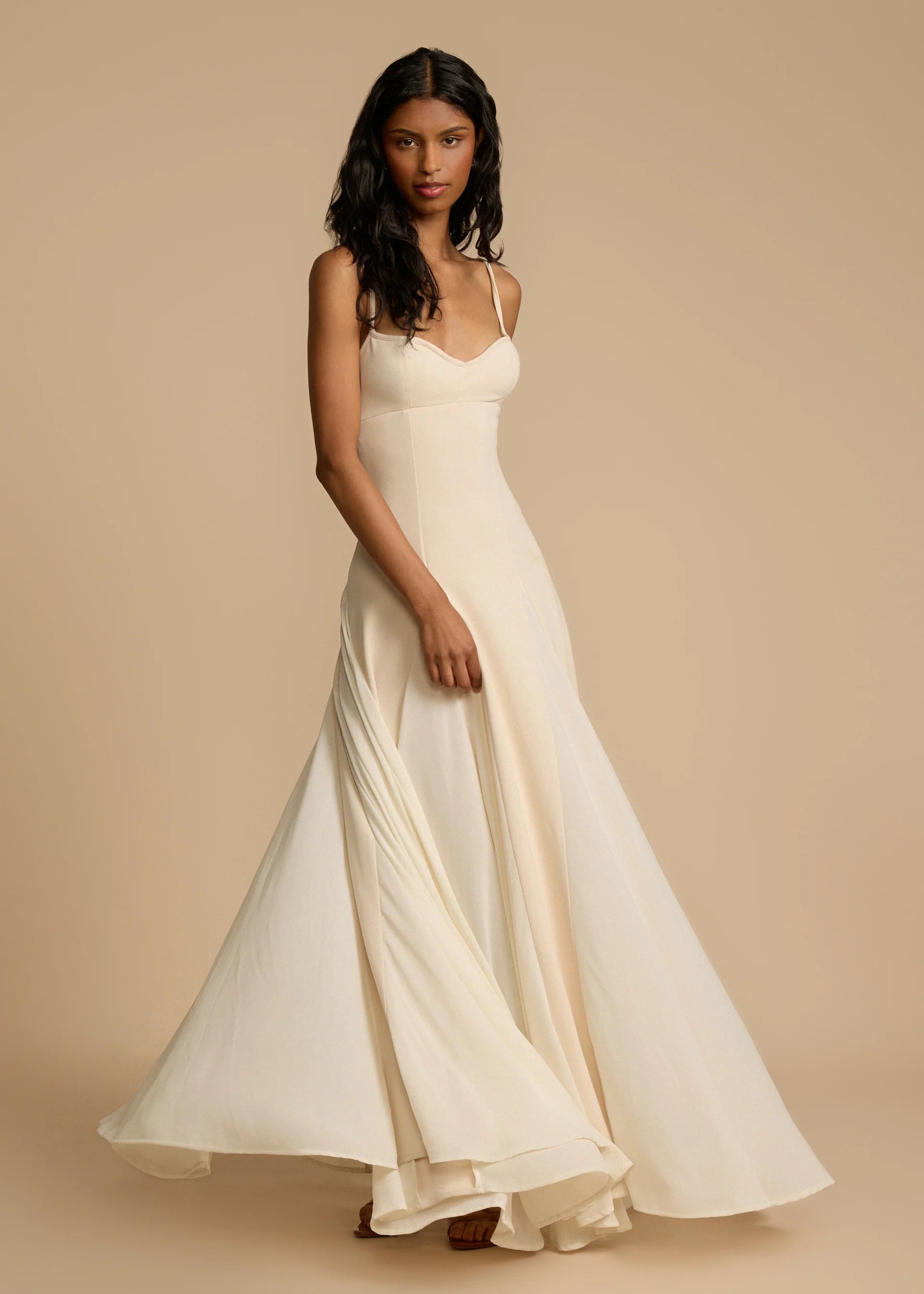 Paloma Dress by Arcina Ori combines classic elegance with modern design, featuring a paneled A-line skirt crafted from white georgette that drapes smoothly off the hips and moves gracefully. Its contrasting accents enhance fluidity, making it ideal for memorable occasions. Equipped with padded bra cups and binded edges, it offers structured support and a flattering silhouette. Paloma delivers refined sophistication and confidence from every perspective.