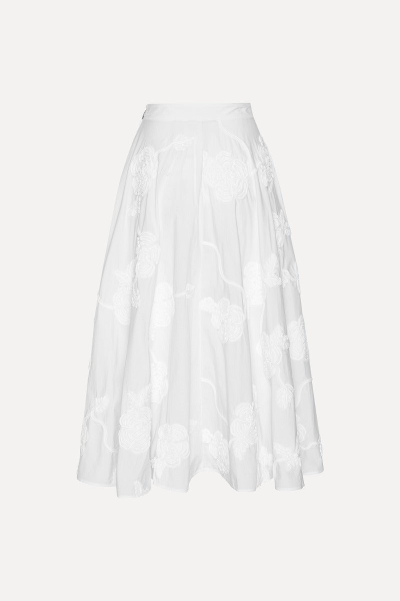 The Flower Maxi Skirt in Bright White combines elegance with comfort through its high-waisted design and voluminous flare, offering a flattering silhouette. Meticulously crafted with tonal floral embroidery, this skirt adds subtle sophistication to any outfit. Soft gathers at the waistband enhance its shape while a concealed side zipper ensures a seamless fit, making it a refined choice for both casual and formal occasions.