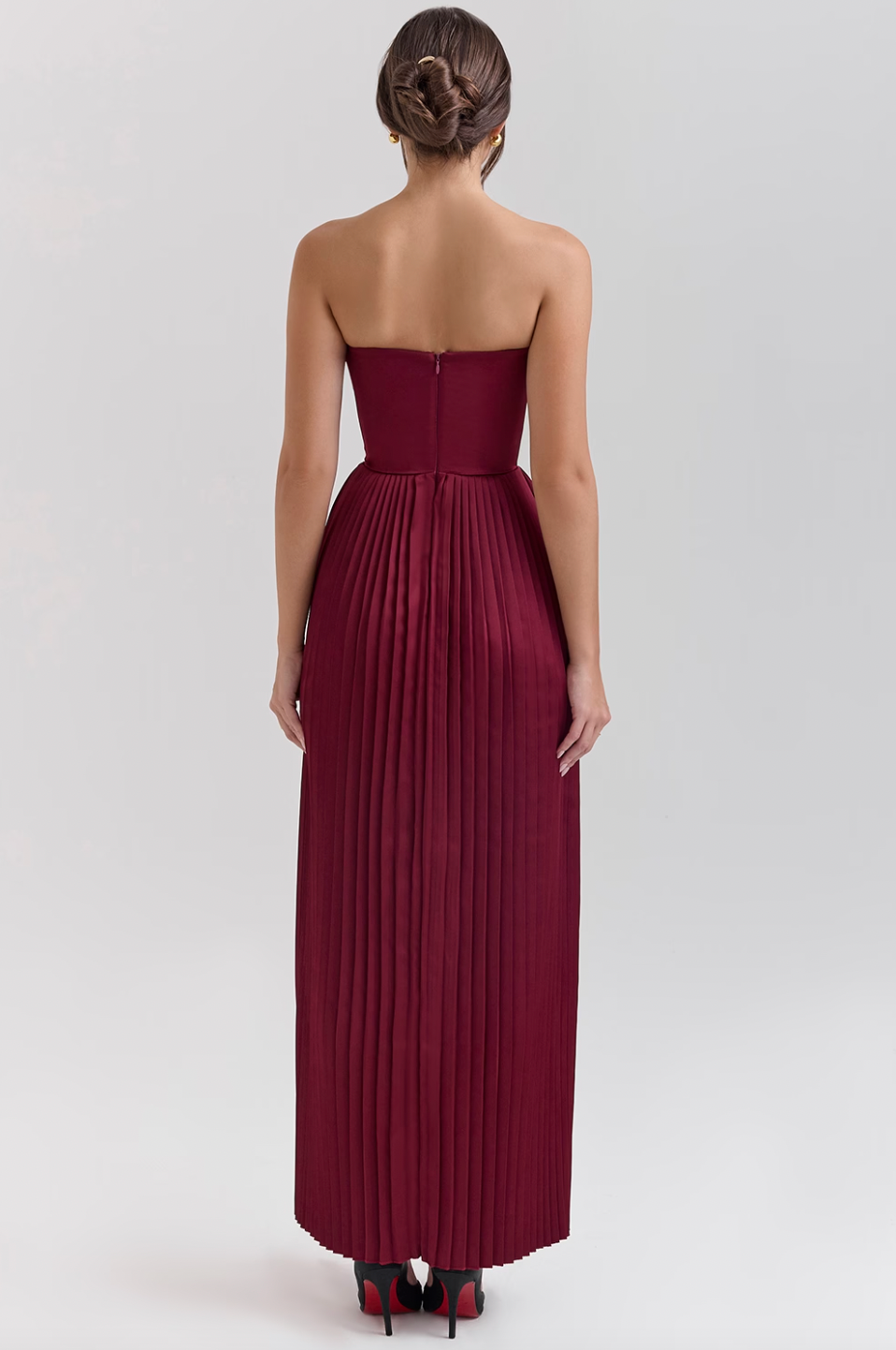 Crafted from luxurious silky pleated satin the ethereal beauty of the 'Marcella' Dress creates a dreamy, romantic silhouette. The bust features elegant shell-shaped pleats that beautifully accentuate your décolletage, while the perfectly boned bodice cinches the waist for a flattering fit. The pleated maxi skirt flows effortlessly, ensuring that every step you take is nothing short of mesmerizing.
 