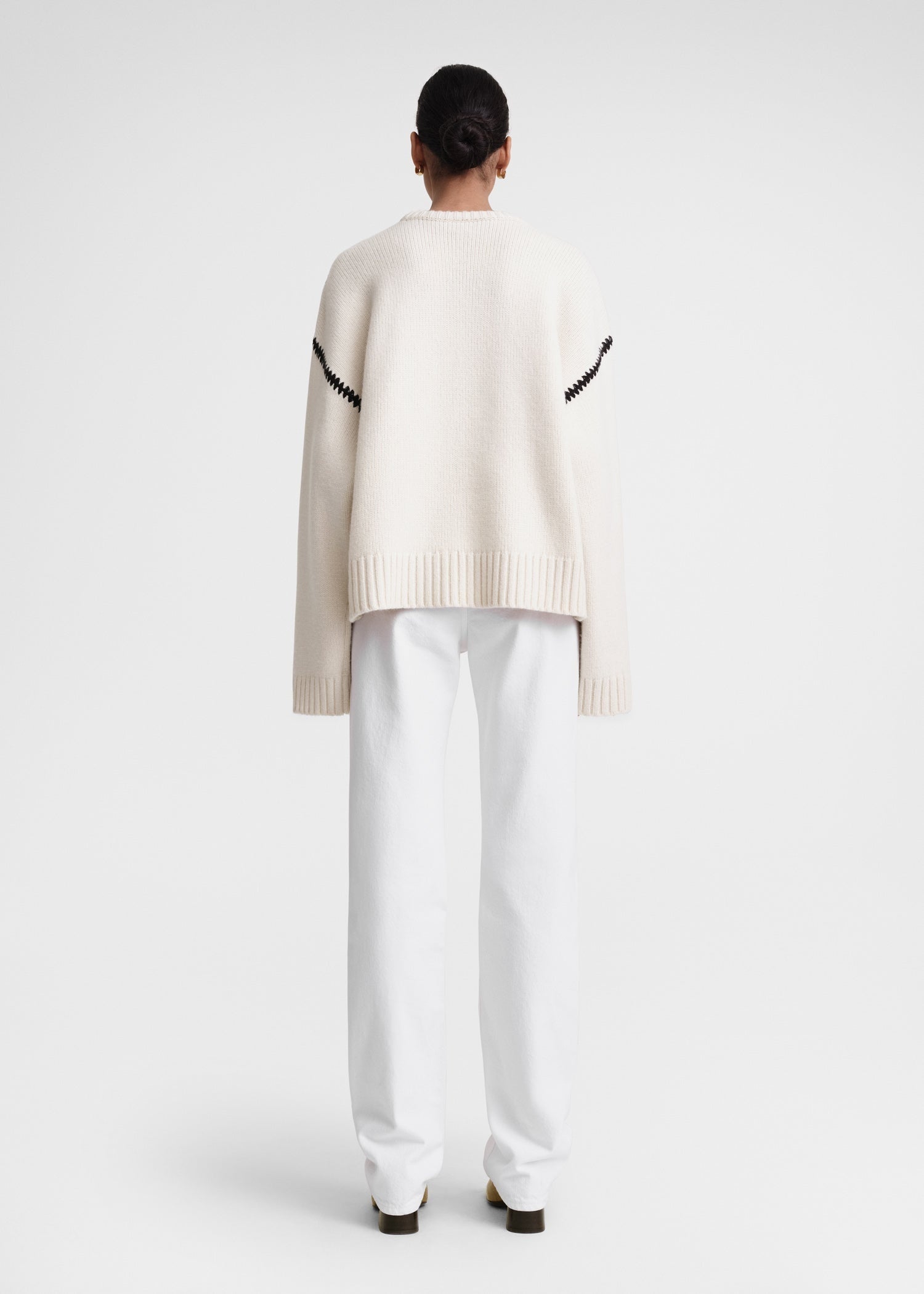 This wide sweater channels the refined aesthetic of TOTEME's Embroidered Scarf Jacket, crafted from mid-weight wool blended with cashmere for superior warmth and softness. Detailed with contrasting thread embroidery along the shoulders and armholes, it adds a sophisticated artisanal touch to classic knitwear. Pair it with the matching scarf to create a cohesive, statement winter ensemble that combines comfort with expert craftsmanship.