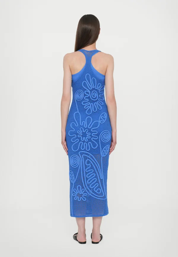 Elevate your wardrobe with the Nissa Dress in Capri by Cult Gaia, featuring a sophisticated sleeveless midi silhouette. Crafted with a delicate netting body, it is beautifully adorned with a detailed floral cord overlay for a refined texture and visual interest. Fully lined with a mini slip, this dress ensures comfortable coverage and ease of wear. Its effortless pull-on design offers convenience without compromising style, making it an ideal choice for elegant day or evening occasions.