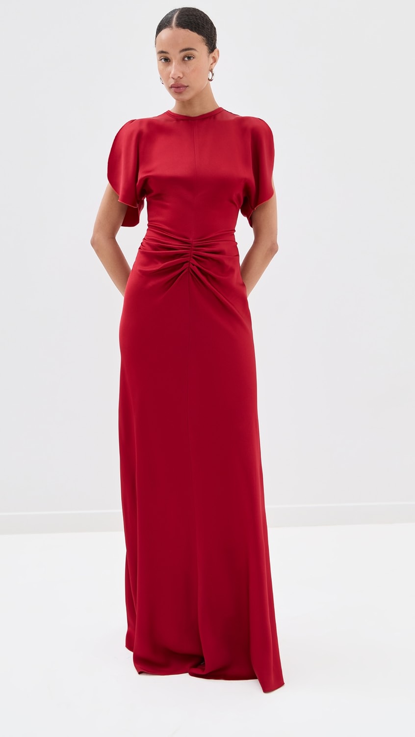 Elegant and refined, this floor-length dress by Victoria Beckham features luxurious mid-weight charmeuse that drapes beautifully without stretch. Strategic ruching at the waist creates a flattering silhouette while the crew neckline and short sleeves offer timeless sophistication. The hidden zip and hook-and-eye closure at the back ensure a seamless finish. Perfect for formal occasions and evening events where polished elegance is paramount.